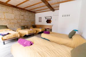 a group of beds in a room at Casa Bubela, O Castro de Dozón. in Dozón
