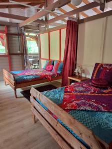 a room with two beds and a couch in it at Kay Lydie in Saint-Joseph