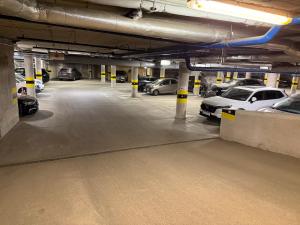 a parking lot with cars parked in a parking garage at Zema11 Old Town Space in Vilnius