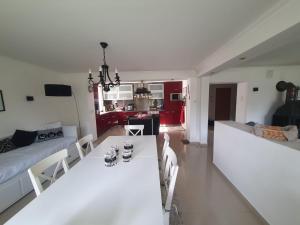 a white living room with a table and a couch at White House in Gronów