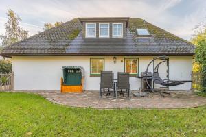 a white house with a patio in front of it at Kastanienhof Sanddorn in Wisch