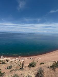 a view of a beach with the ocean at Marjan Guest House in Bokonbayevo