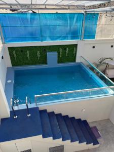 a swimming pool with blue water in a building at Casa Apartment Playa Tortugas in Tortuga +35 photos