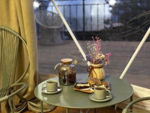 a table with two cups of coffee and a plate of food at Trichk Resort in Goris +28 photos