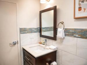 a bathroom with a sink and a mirror at Manta Lodge and Dive Centre in Speyside +34 photos