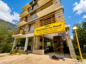 a building with a sign that reads hotel dance inn marriott at Hotel Deluxe Inn Manali in Manāli