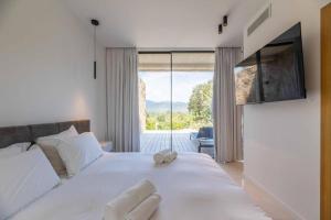a bedroom with a bed with a teddy bear on it at Hotel Monte Sereno in Zonza