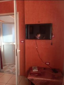 a tv on the wall of a room at Oumayma in Sousse