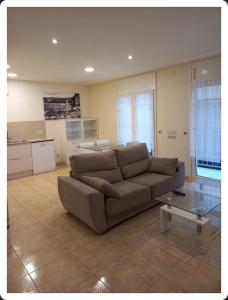 a living room with a couch and a table at Apartament Balcó in Sant Quirze de Besora