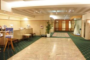 a lobby of a hotel with a wedding dress on display at Racine Shinmaebashi in Maebashi