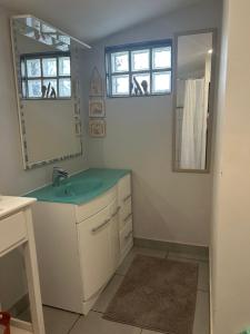 a bathroom with a sink and a mirror at Gîte en Baie de Somme in Saint-Blimont +13 photos