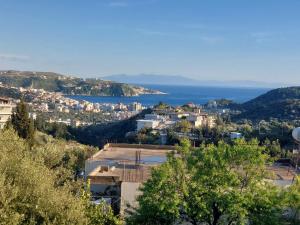 a view of a city and the ocean at Laertis house in Himare