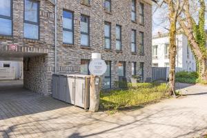 a sign in front of a brick building at SEASIDE APARTMENTS - BEACHHOUSE BLUE in Eckernförde