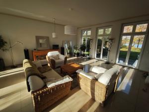 a living room with two couches and a table at Trentsee Chalet in Malente