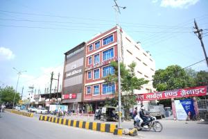 a building on the side of a city street at Hotel Vishnu Vilas in Rewa