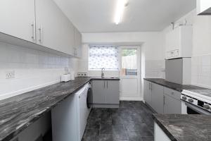 a kitchen with white cabinets and a counter top at Henley Haven in Pelton Fell