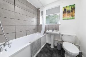 a white bathroom with a toilet and a sink at Henley Haven in Pelton Fell +43 photos