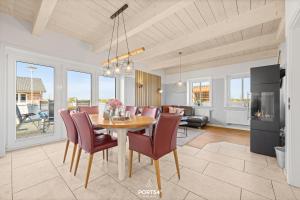 a kitchen and dining room with a table and chairs at Ferienhaus Philomena Dagebüll in Dagebüll