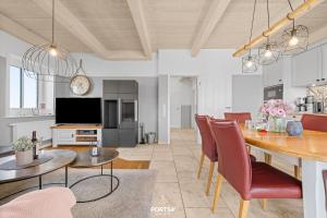 a kitchen and dining room with a table and chairs at Ferienhaus Philomena Dagebüll in Dagebüll