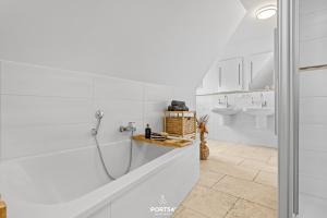 a white bathroom with a shower and a sink at Ferienhaus Philomena Dagebüll in Dagebüll +29 photos