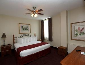 ein Hotelzimmer mit Bett und Deckenventilator in der Unterkunft Arrow Hotel in Broken Bow