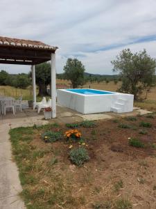 a swimming pool in a yard with a pavilion at Cabana do Compadre in Vila Nova da Baronia