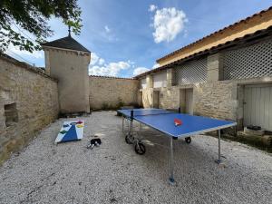 a blue ping pong table in a courtyard at Chateau de Briand in Luxé