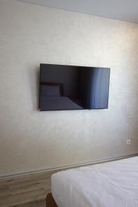 a tv on the wall of a bedroom at СічSich in Kolomiya