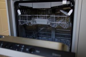 a dishwasher with dishes inside of it at СічSich in Kolomiya +9 photos