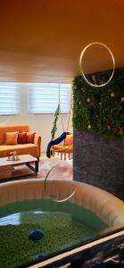 a living room with a tub in the middle of a room at Apartman - Jacuzzi Spa - Tvrđava Travnik in Travnik