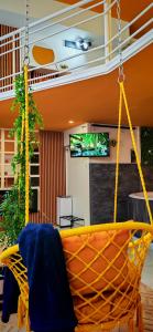 a swing in a living room with a couch at Apartman - Jacuzzi Spa - Tvrđava Travnik in Travnik