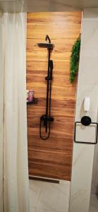 a room with a wooden wall with a iron stand at Apartman - Jacuzzi Spa - Tvrđava Travnik in Travnik +62 photos