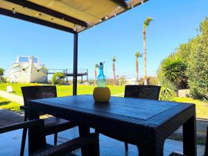 a blue table with a vase on top of it at Psalidi beach house in Psalidi