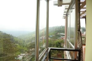 a view from the window of a house at sunshine retreat in Coonoor