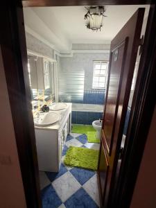a bathroom with a sink and a toilet and a mirror at Vio's Home in Serra de El-Rei