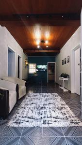 a bedroom with a bed and a rug on the floor at Nônames Urban Hostel in Florianópolis