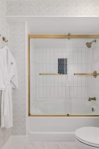 a bathroom with a shower with a toilet and a sink at Elizabeth Pointe Lodge in Fernandina Beach +46 photos