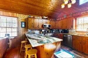 a kitchen with wooden cabinets and a large counter top at Coos Moose in Ellijay +10 photos