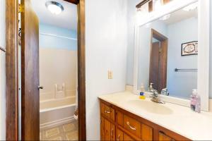 a bathroom with a sink and a mirror at Coos Moose in Ellijay