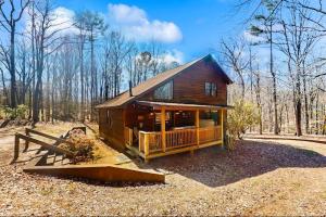 a small house in the middle of a forest at Coos Moose in Ellijay