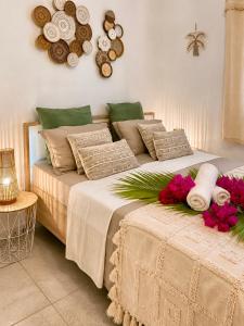 a bedroom with a bed with flowers on it at Villa Docéa in Sainte-Anne +52 photos