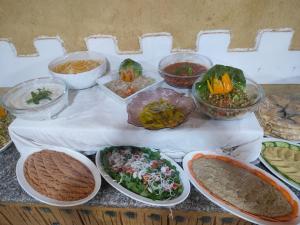 a table topped with bowls of different types of food at Eva camp in Disah