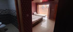 a small room with a bed and a window at Eva camp in Disah