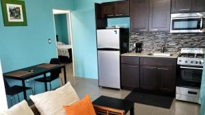 a kitchen with a white refrigerator and a table at Eden Apartments in Basseterre