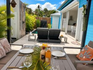 a patio with a table with wine glasses on it at Villa Docéa in Sainte-Anne