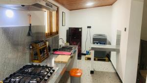 a kitchen with a stove top oven in a room at Mayon villa in Midigama East +17 photos