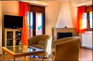 a living room with a tv and a fireplace at Anavissos pool appartment in Anavyssos