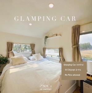 a bedroom with a large bed in front of a window at SOL Glamping at Khao yai in Ban Nong Makha