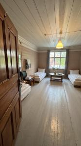 a large room with two beds and a table at Ambra Apartaments Palanga in Palanga +19 photos