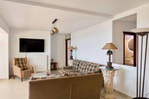 a living room with a couch and a table at 180 View Private 2 Bedroom Seaview Home in Samos